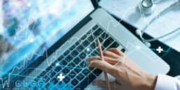 Digital collage showing a laptop with graphs layered