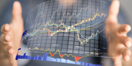 graphic artwork showing multi colored digital charts imposed between 2 hands