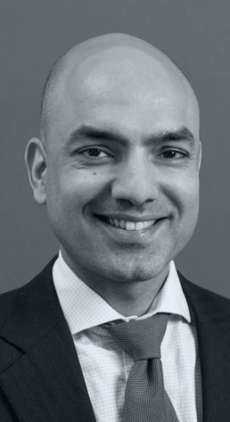 A black and white head shot of Kirat Singh